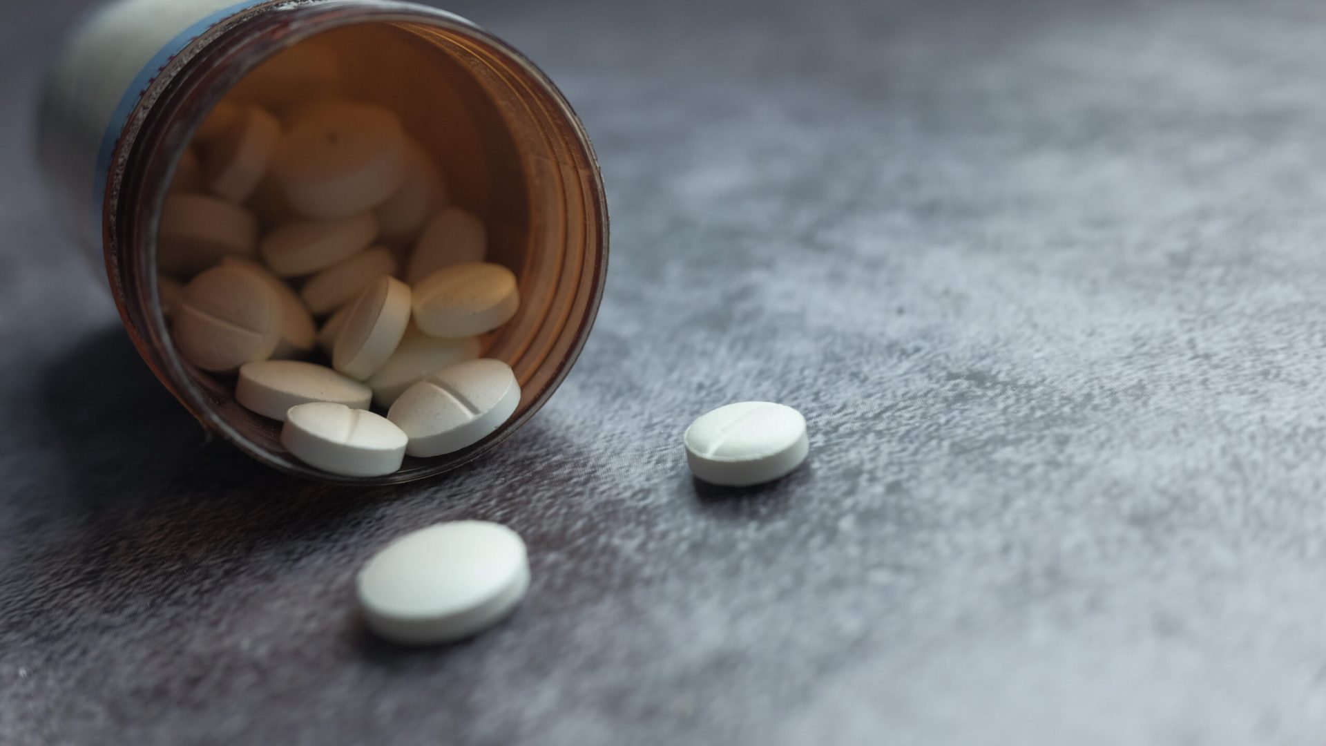 Color,Pills,Spilling,From,Container,On,Dark,Background,,Close,Up