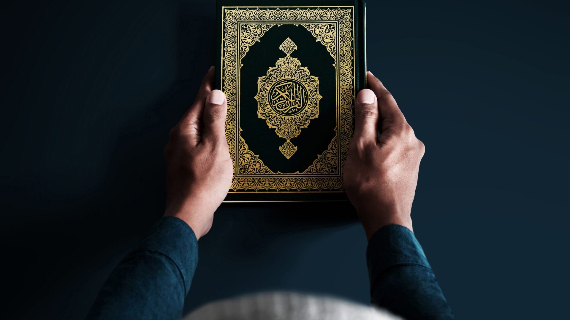 Man,Holding,Holy,Book,On,Dark,Background