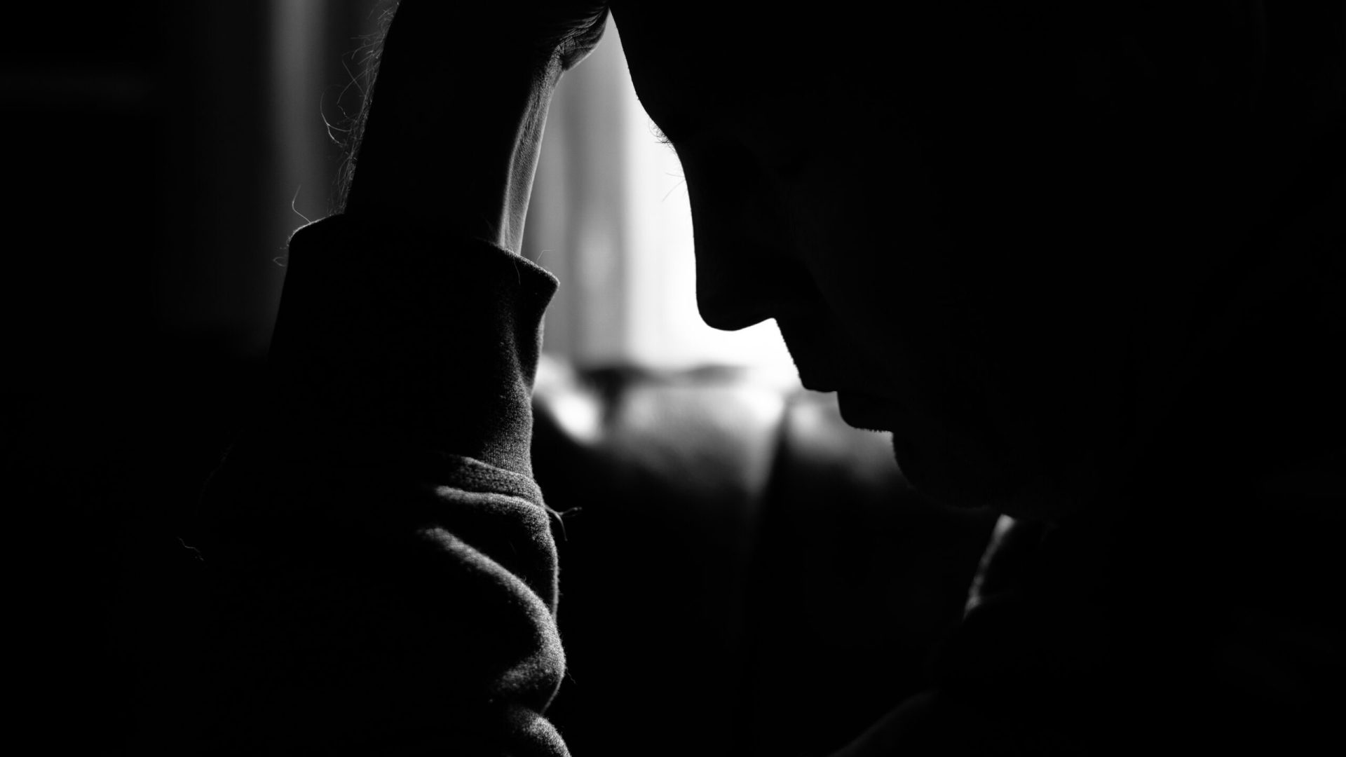 Monochrome,Photo,Of,A,Depressed,Man,Silhouetted,By,The,Light