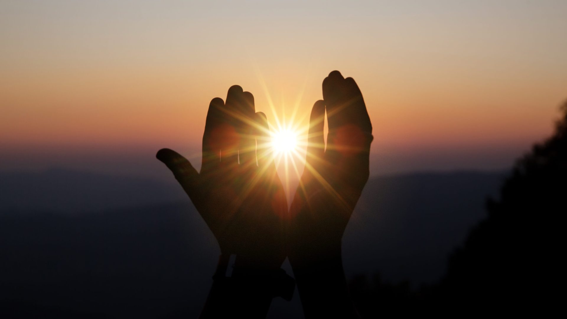 Faith of christian concept: Spiritual prayer hands over sun shine with blurred beautiful sunset background